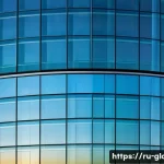 Home 22 유리공예와 건축 유리 디자인 - A modern architectural facade featuring large multilayer laminated glass panels embedded with nanopa...